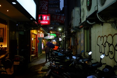 Stop at the shop next to the black motorcycle at night
